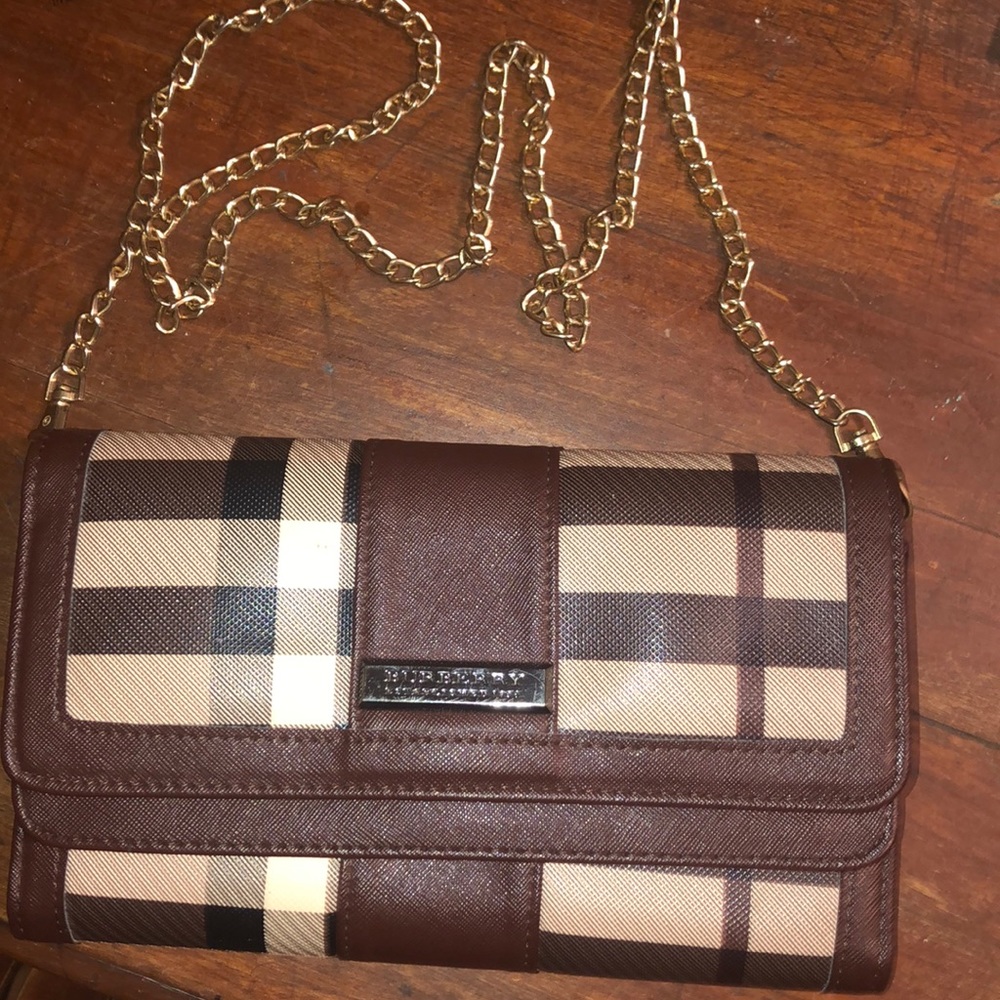 Small brown Burberry crossbody purse.